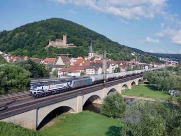 Whole VTG train on rail bridge with houses in background