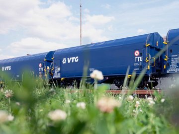 Three blue VTG standard freight wagons.