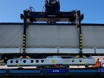 Container is loaded onto a wagon.