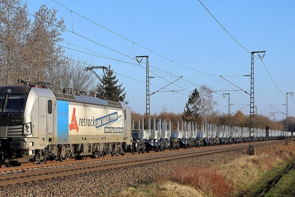 Retrack locomotive on rail pulls intermodal wagon with modular superstructures