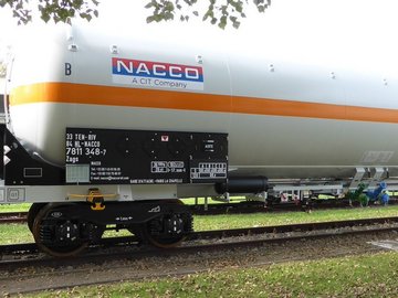 White liquid gas tank car with orange stripe.