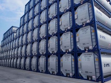 Many VTG tank containers stacked on top of each other.