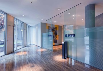 Entrance area of an office building with glass doors.