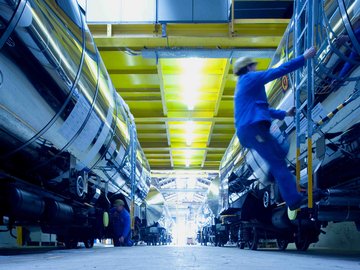 Employee in protective clothing climbs onto a wagon