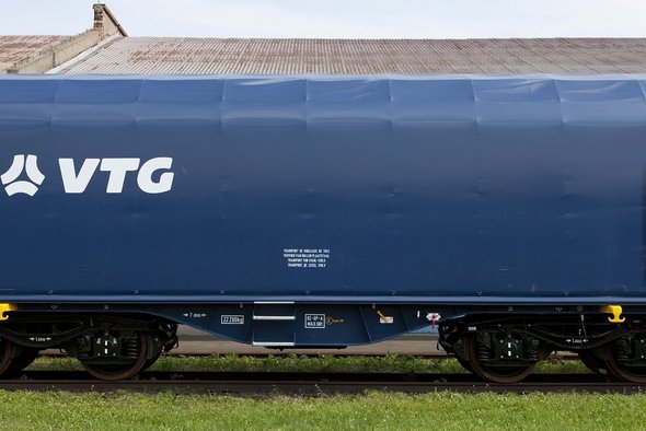 Blue flat car with white VTG logo on one rail.