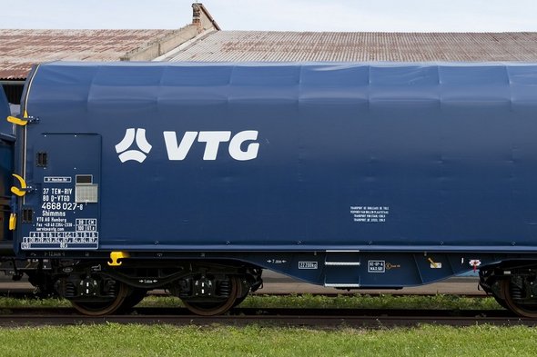 Blue flat car with white VTG logo on one rail.
