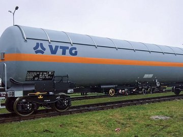 Gray liquid gas tank car with orange stripe and blue VTG logo.