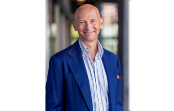 Smiling man in blue suit and bald head