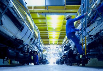 Employee in protective clothing climbs on a wagon