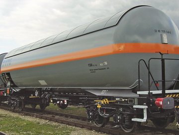 Interlocking white liquid gas tank cars with orange stripe.